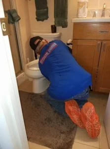 Stang Plumbing service technician repairing a residential toilet in Maryland