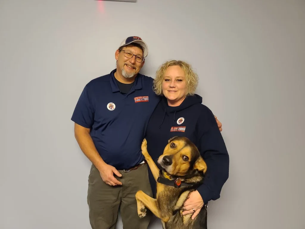 Jon and Dawne Hershberger, owners of Stang Plumbing in Maryland, with family dog