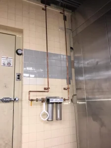 Whole-home water filtration and treatment system installed with copper piping